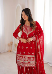 Woman wearing a red embroidered traditional outfit with a white background