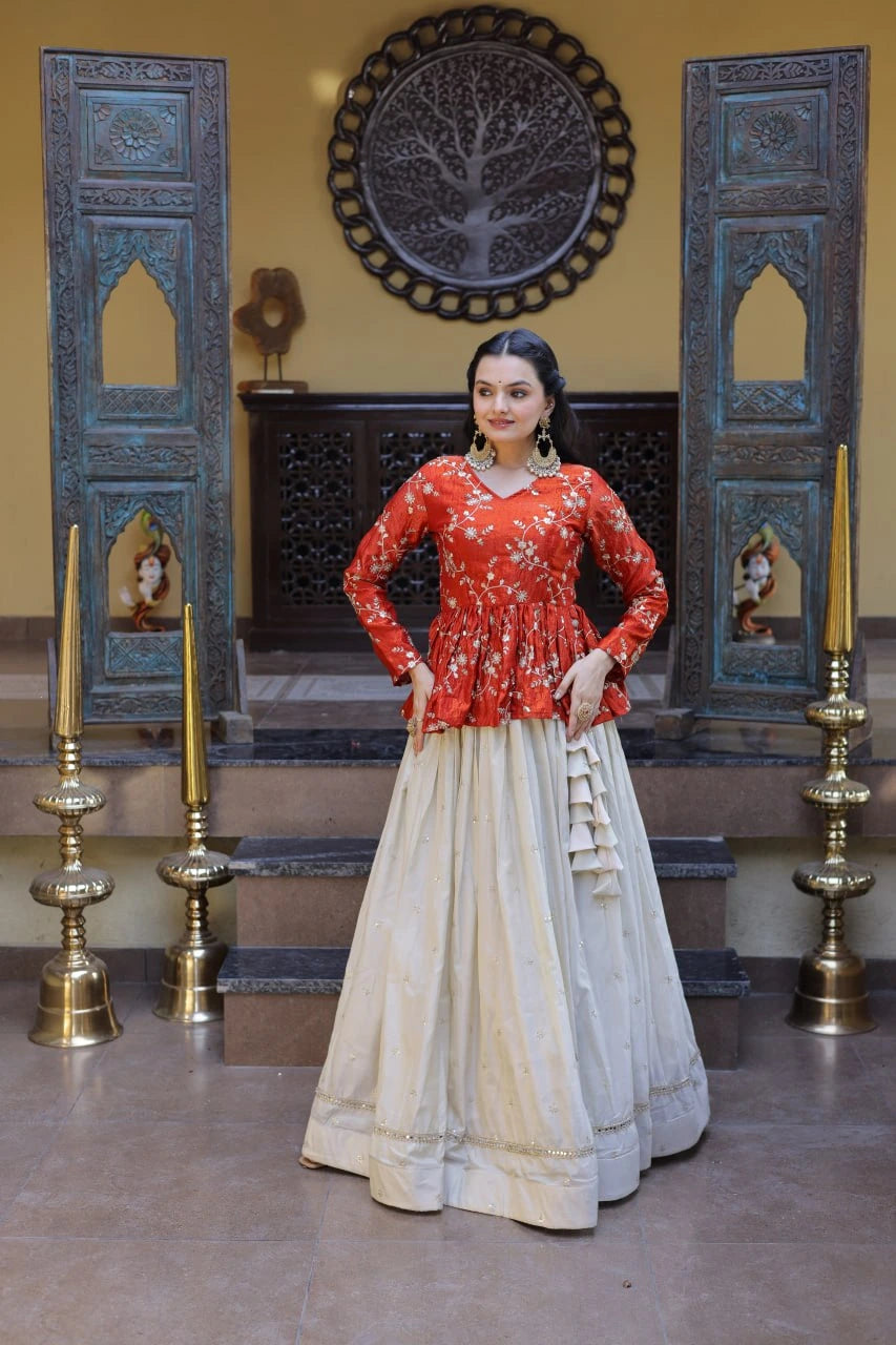 Woman in traditional outfit standing in a decorated room with ornate doors and wall art.