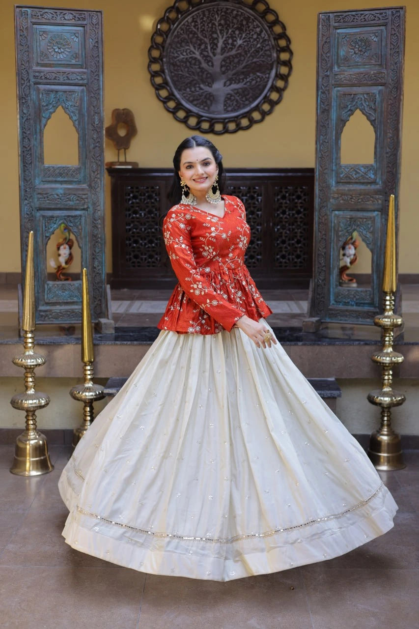 Woman in a red top and white skirt standing in a decorated room with candles and decorative elements.