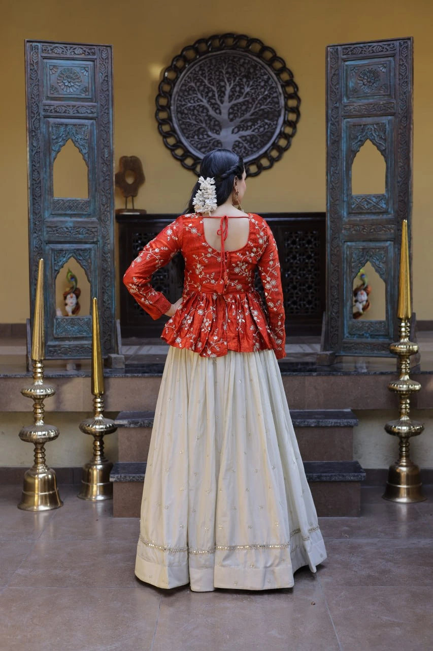 Person wearing a red blouse and beige skirt in a decorated room with blue panels and candles.