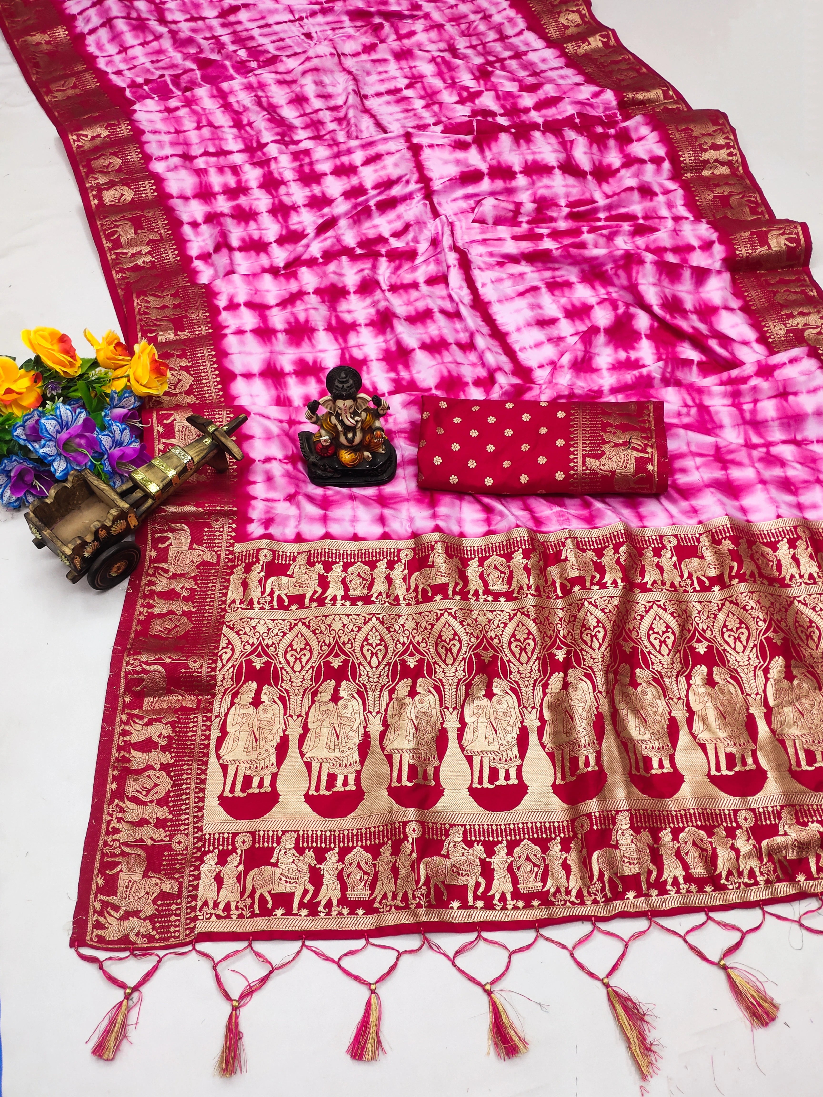 Traditional saree with pink and red patterns on a white background