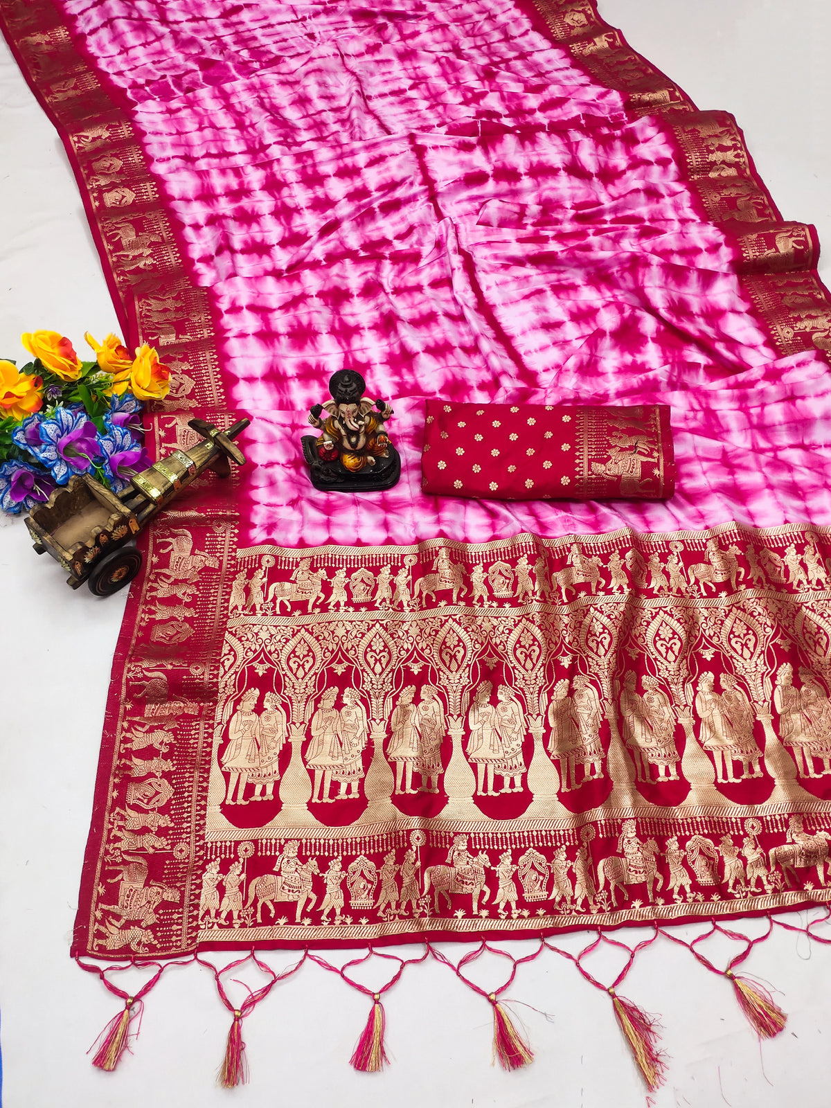 Traditional saree with pink and red patterns on a white background