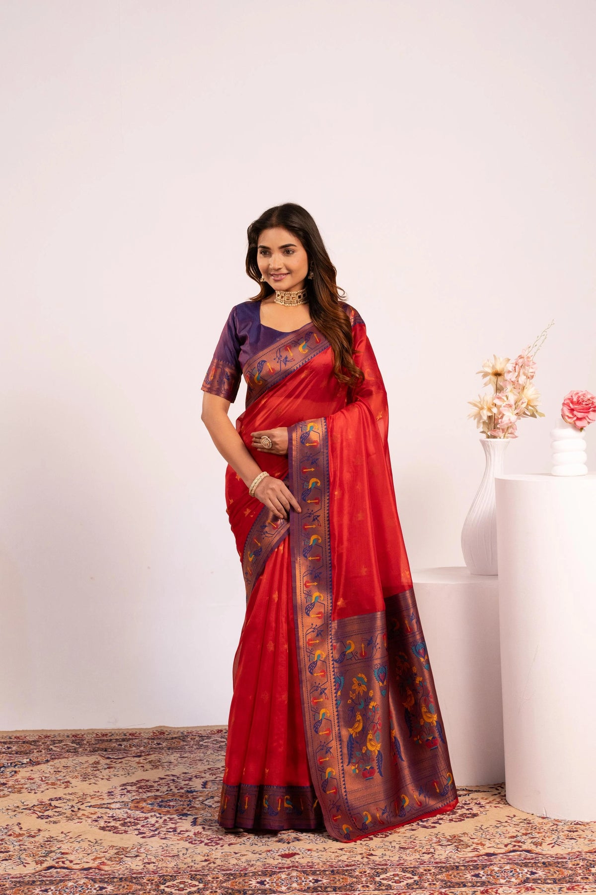Woman wearing a red saree with a white background