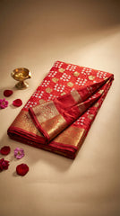 Red saree with gold patterns on a beige background