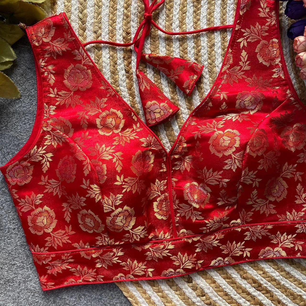 Red floral-patterned top on a textured surface