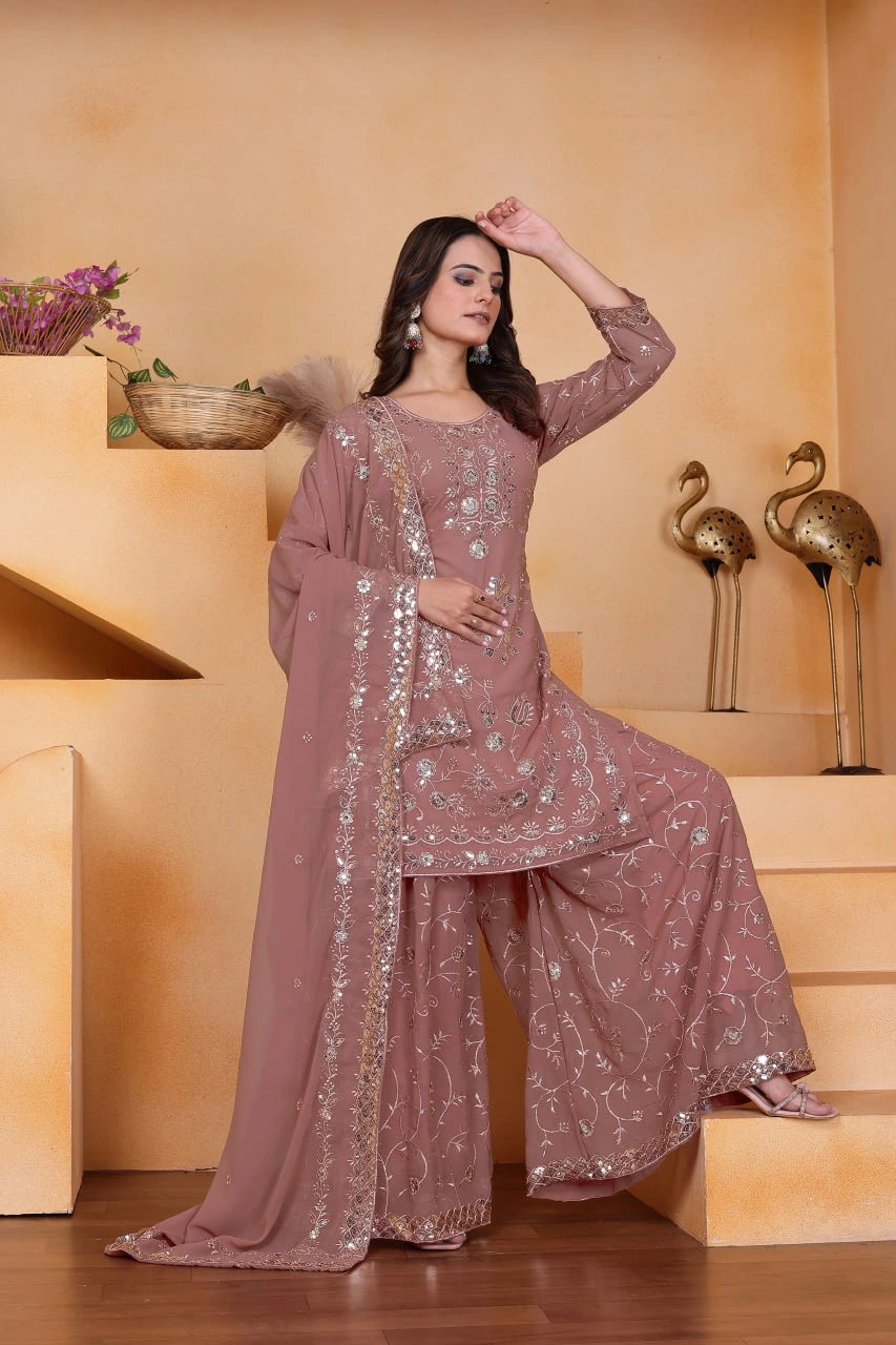 Woman in a pink traditional outfit with sequin details on a beige background