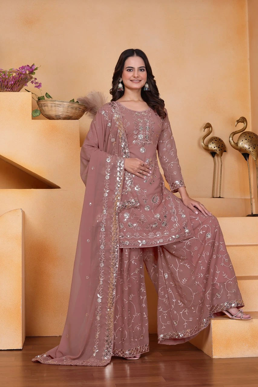 Woman in a pink traditional outfit with sequins on a beige background