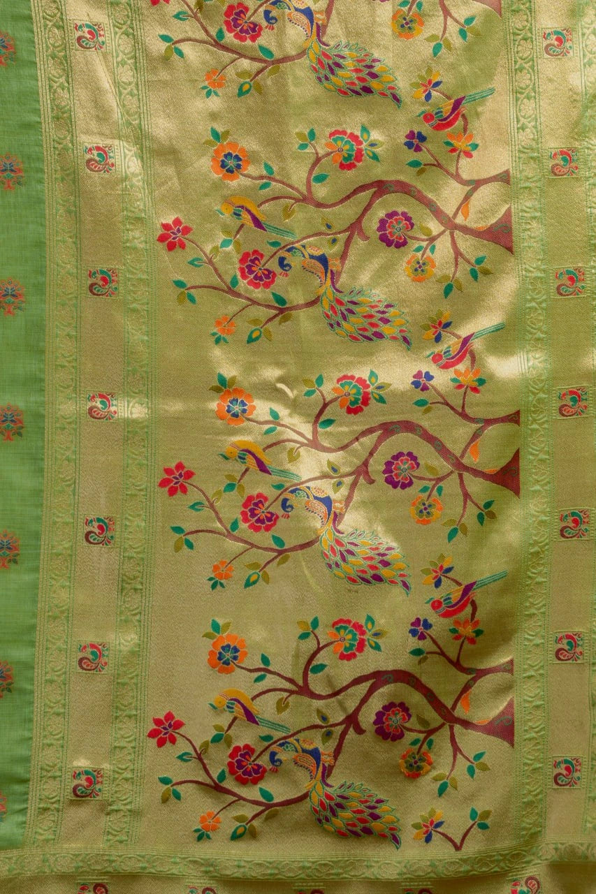 Decorative fabric with floral and bird embroidery on a green background