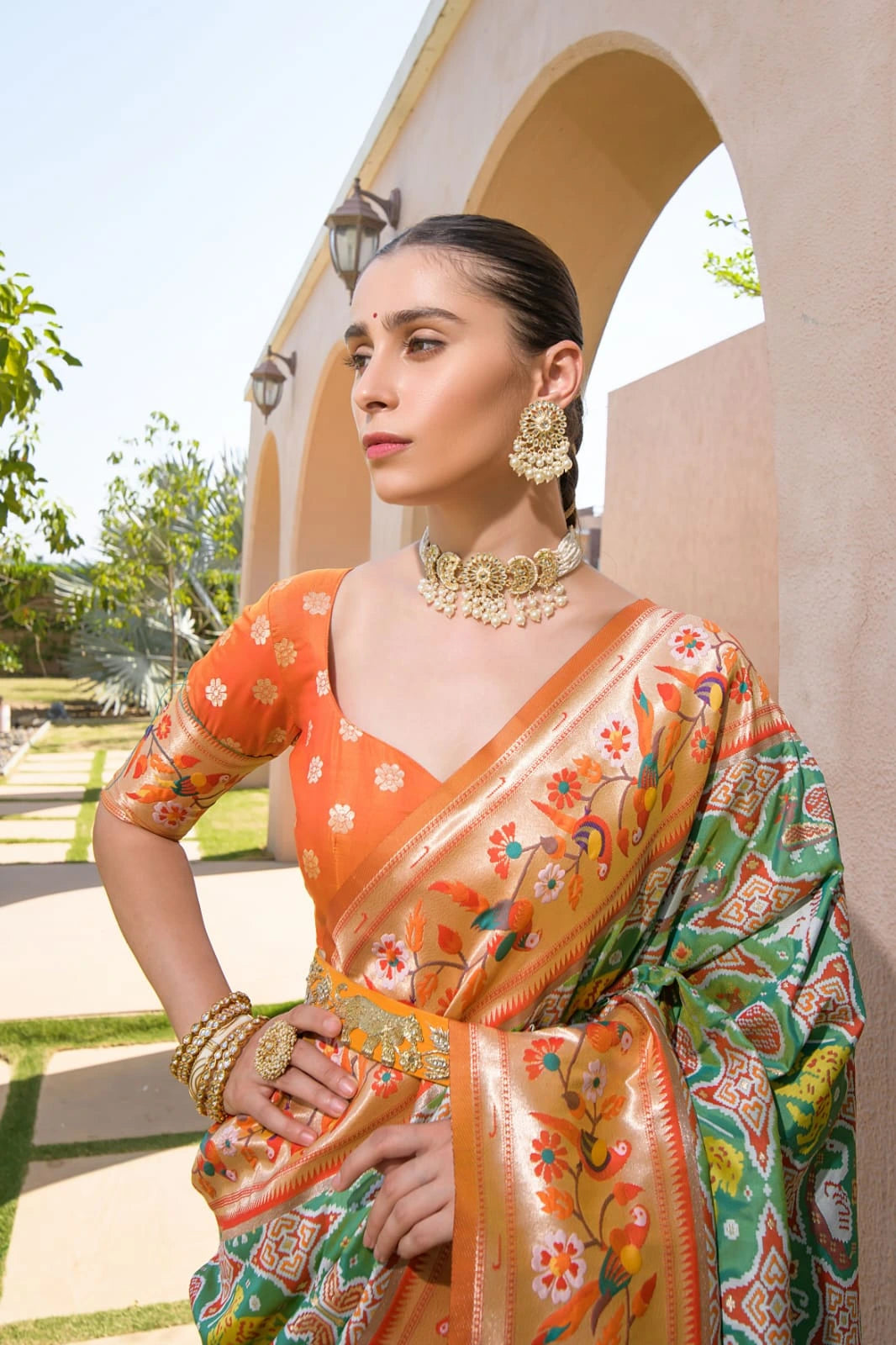 Orange and green Paithani silk saree with floral zari border and traditional motifs