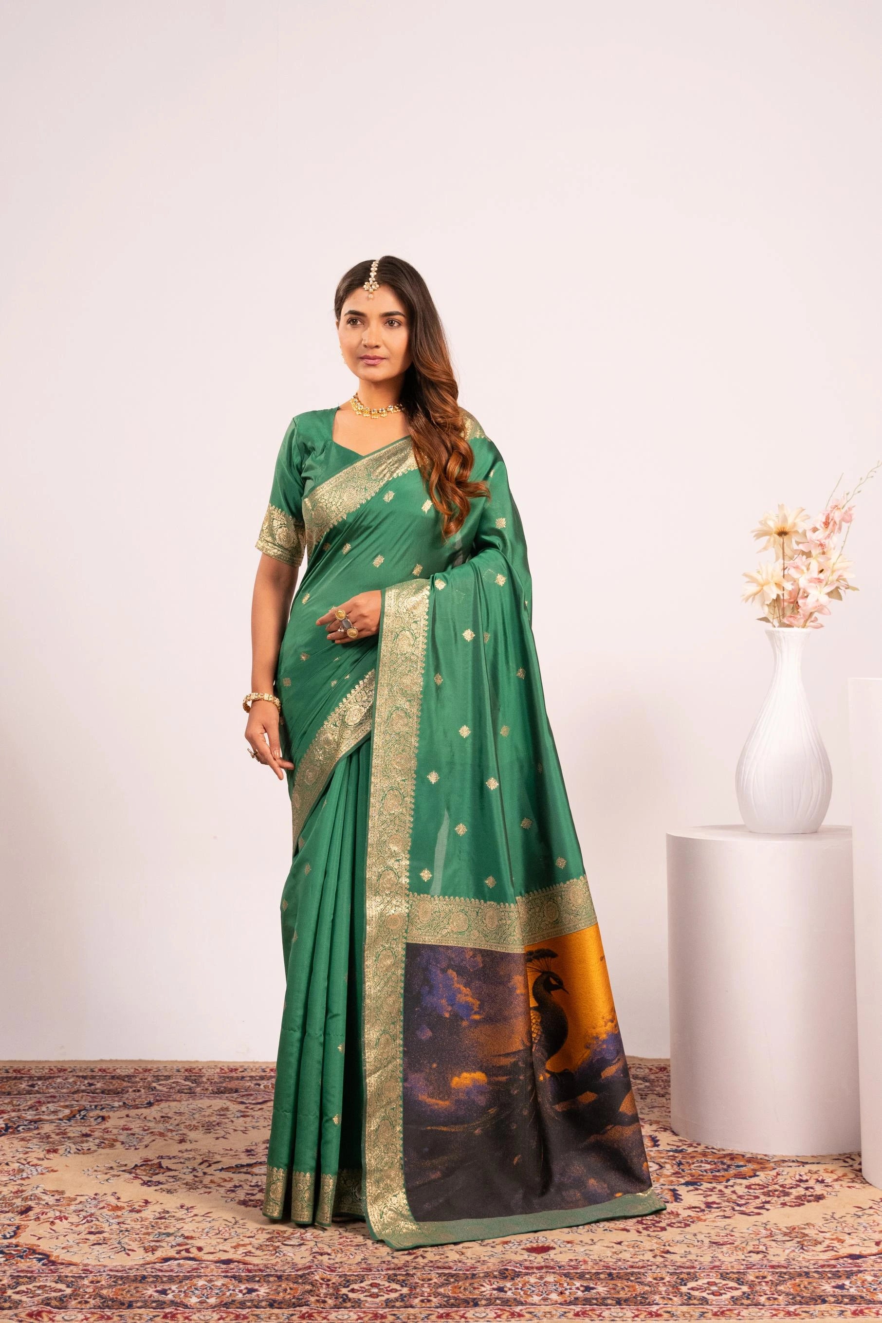 Woman wearing a green saree with a white background