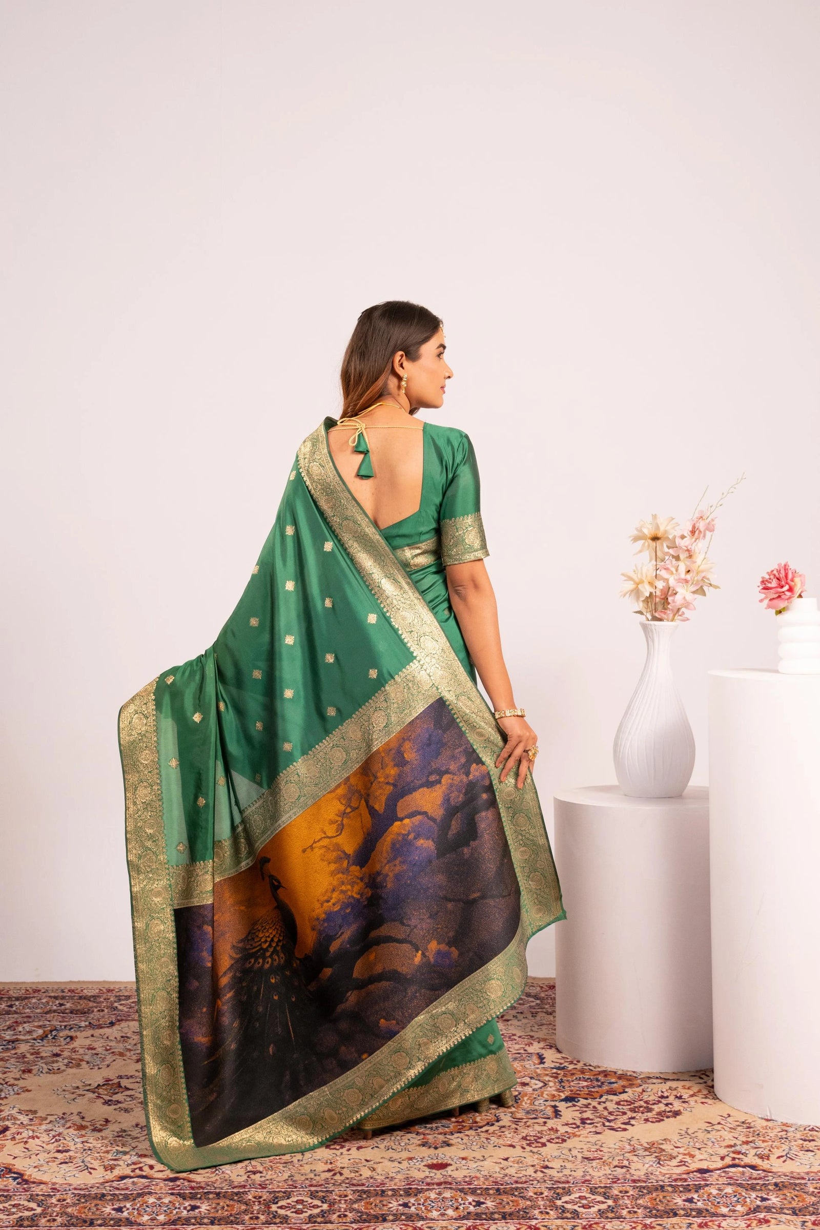 Woman wearing a green saree with a white background
