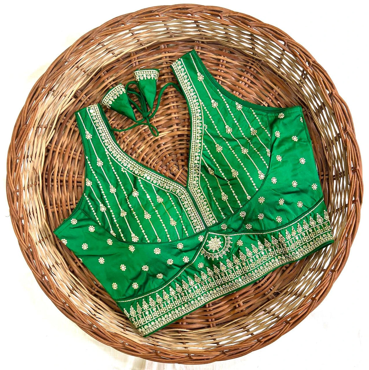 Green embroidered blouse on a woven basket