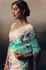 Woman holding a floral handbag against a gradient background