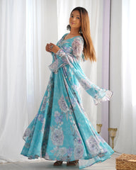 Woman wearing a floral dress standing in front of white curtains