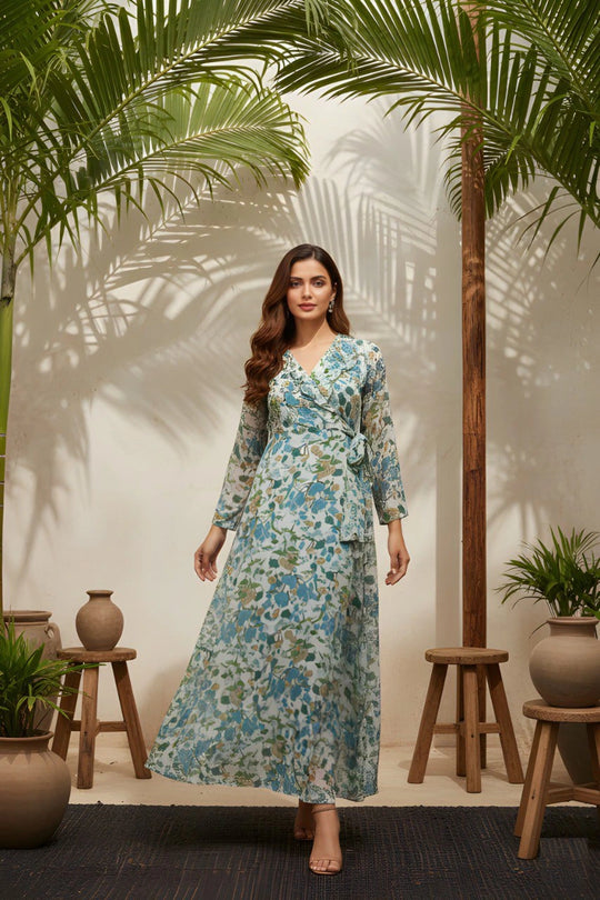 Woman in a floral dress standing in a tropical setting with palm trees and plants.