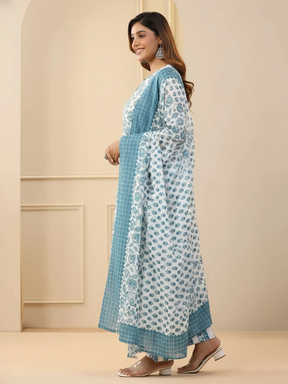 Woman wearing a blue and white patterned dress in an indoor setting
