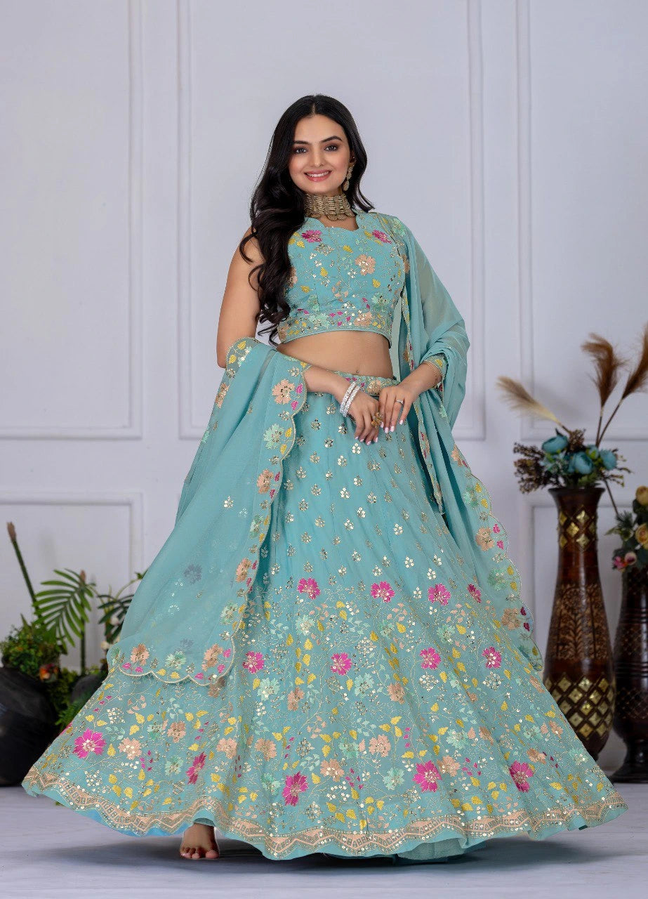 Woman wearing a light blue embroidered lehenga with a white background