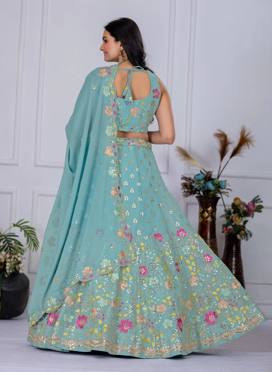 Woman wearing a light blue embroidered lehenga with a matching dupatta in a minimalistic setting.