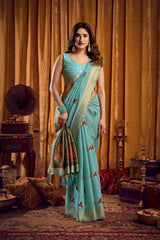 Woman in a light blue saree with a traditional setting