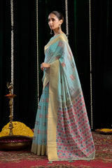 Woman in a traditional saree with a patterned design on a dark background
