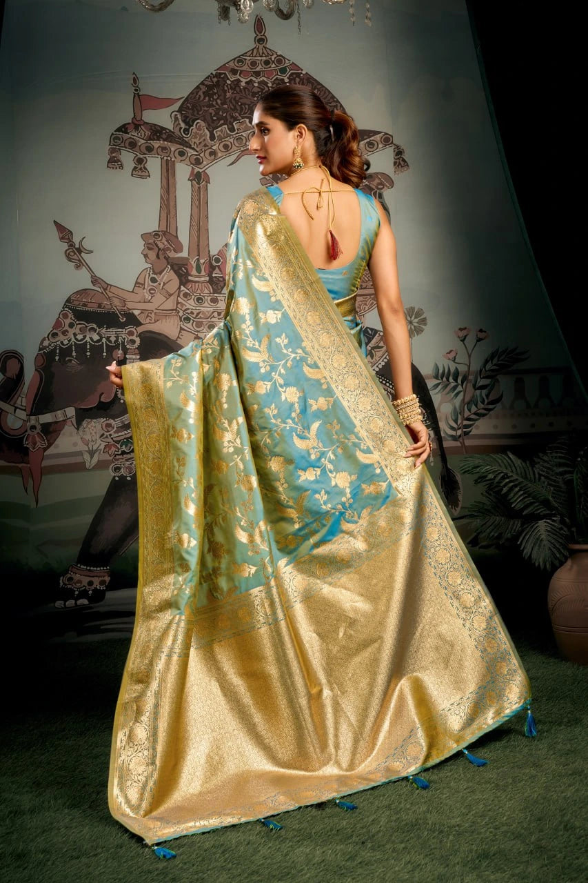 Woman in a gold and blue saree with a decorative background