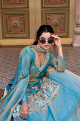 She accessorizes with statement earrings and stylish black sunglasses.
