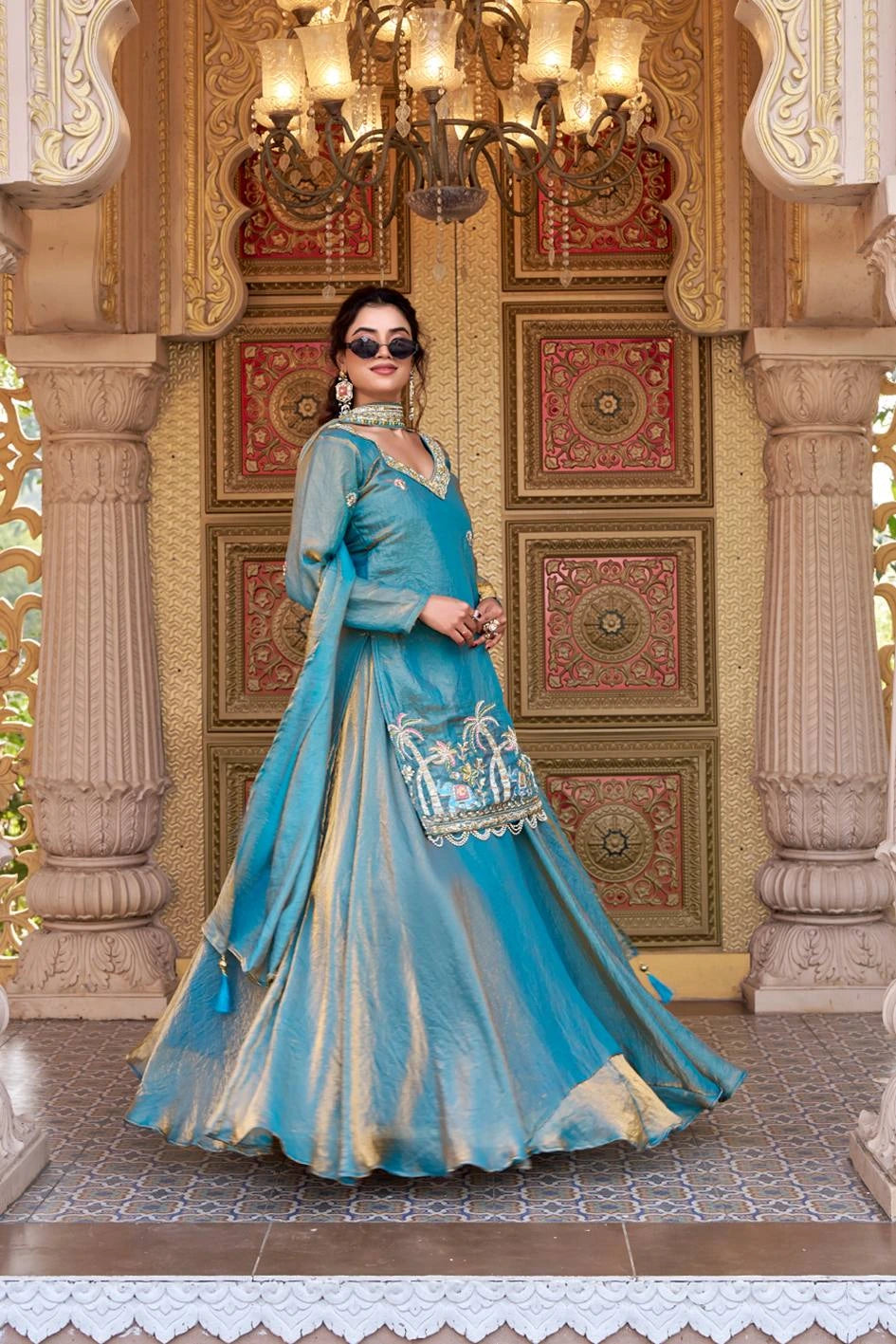 The dress features delicate floral embroidery and decorative patterns near the hemline.
