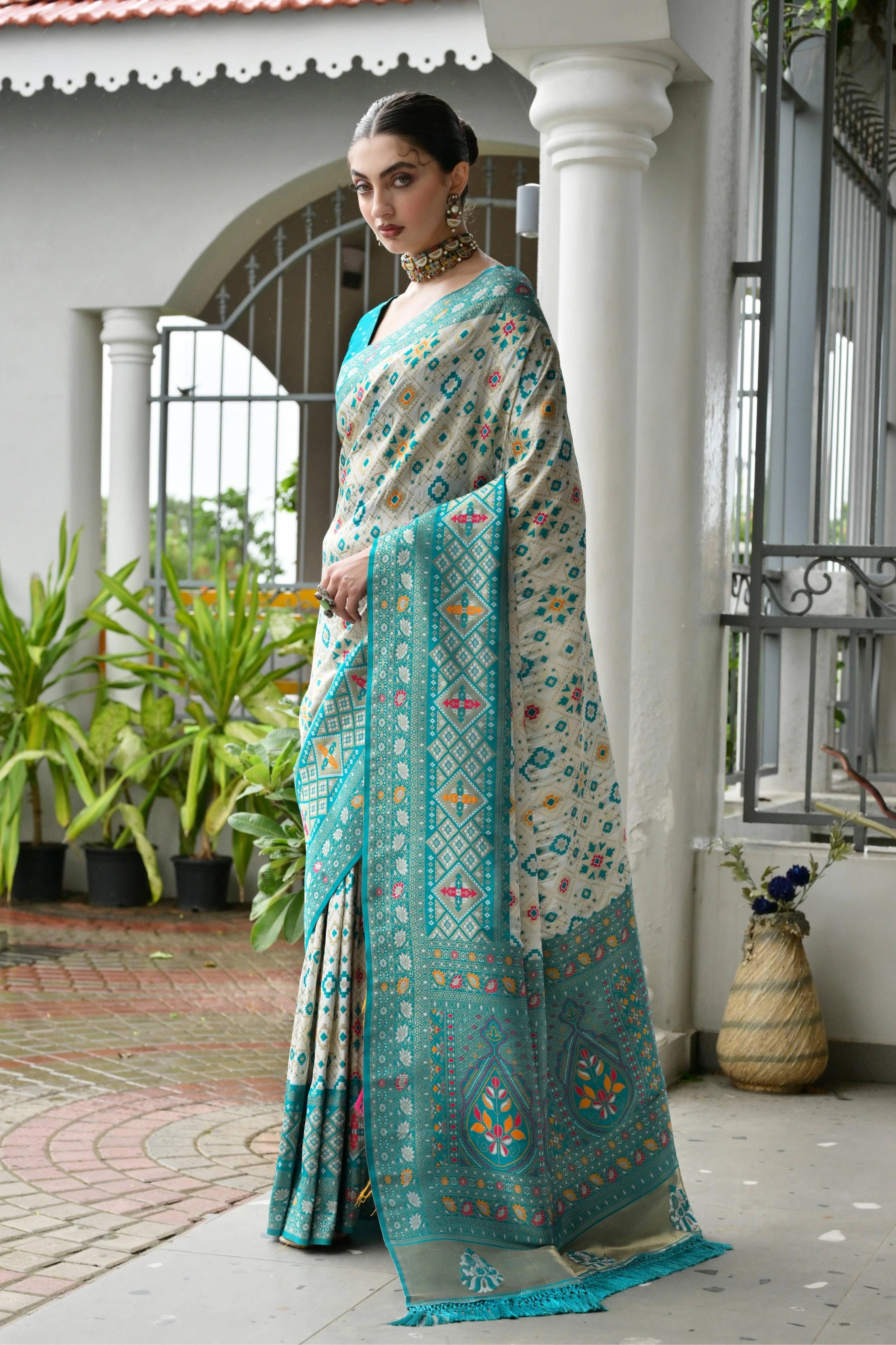 Sky blue Banarasi silk saree with golden zari weaving displayed on mannequin.