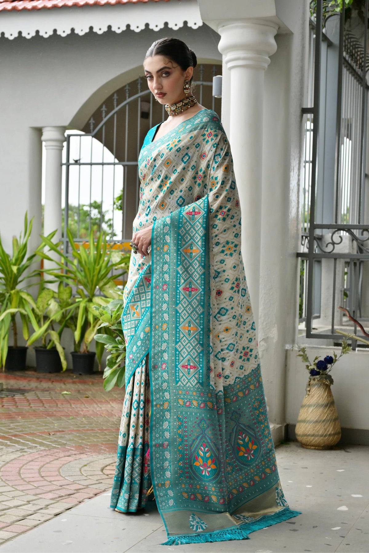 Sky blue Banarasi silk saree with golden zari weaving displayed on mannequin.