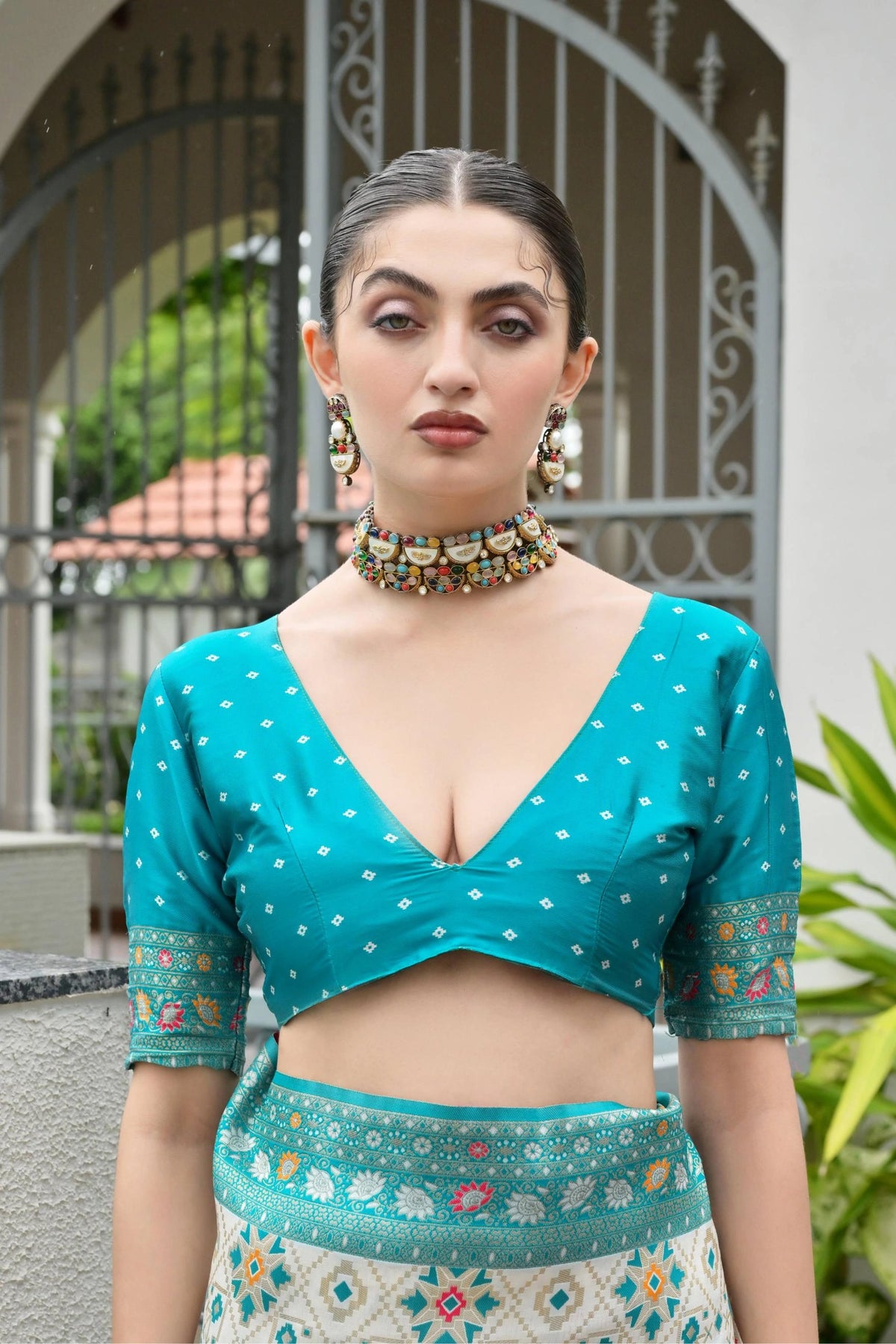 Close-up of sky blue silk saree highlighting shimmering golden zari craftsmanship.