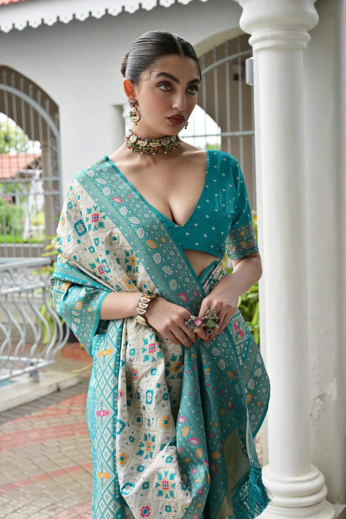 Close-up of sky blue silk saree highlighting shimmering golden zari craftsmanship.