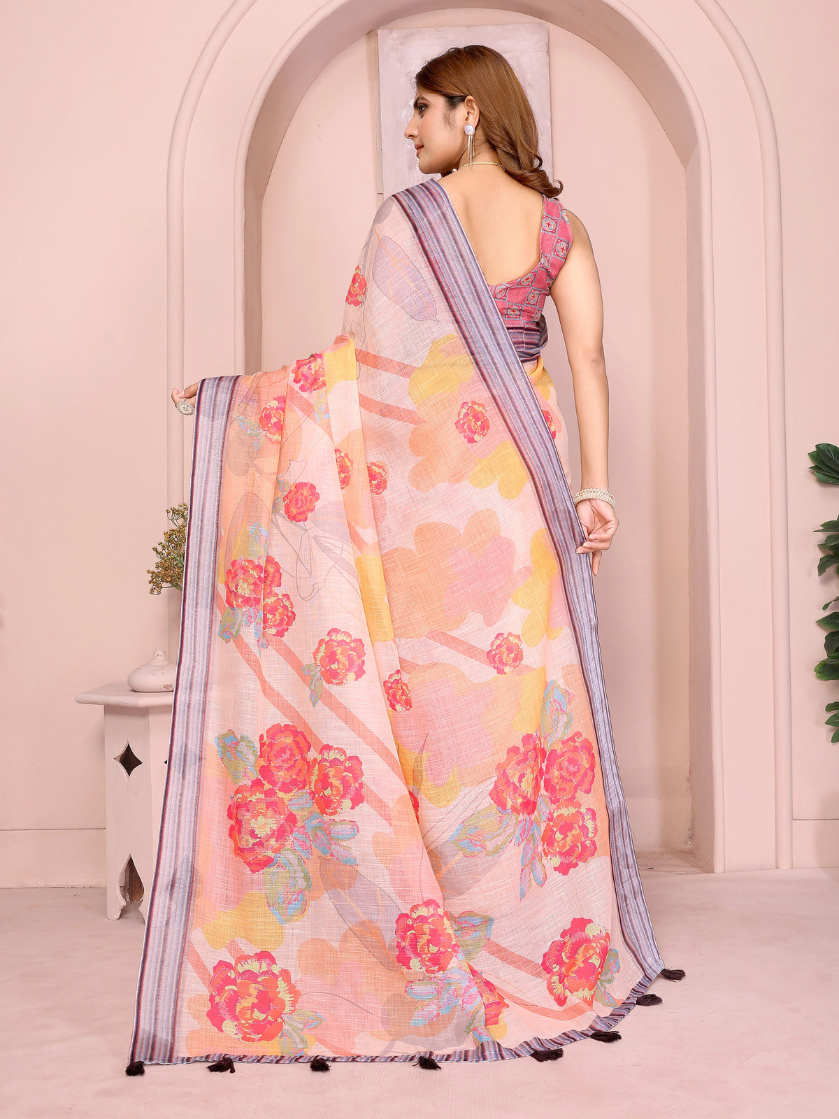 Back view of Soft Peach Floral Print Saree in Linen Cotton showing blouse back and pallu drape
