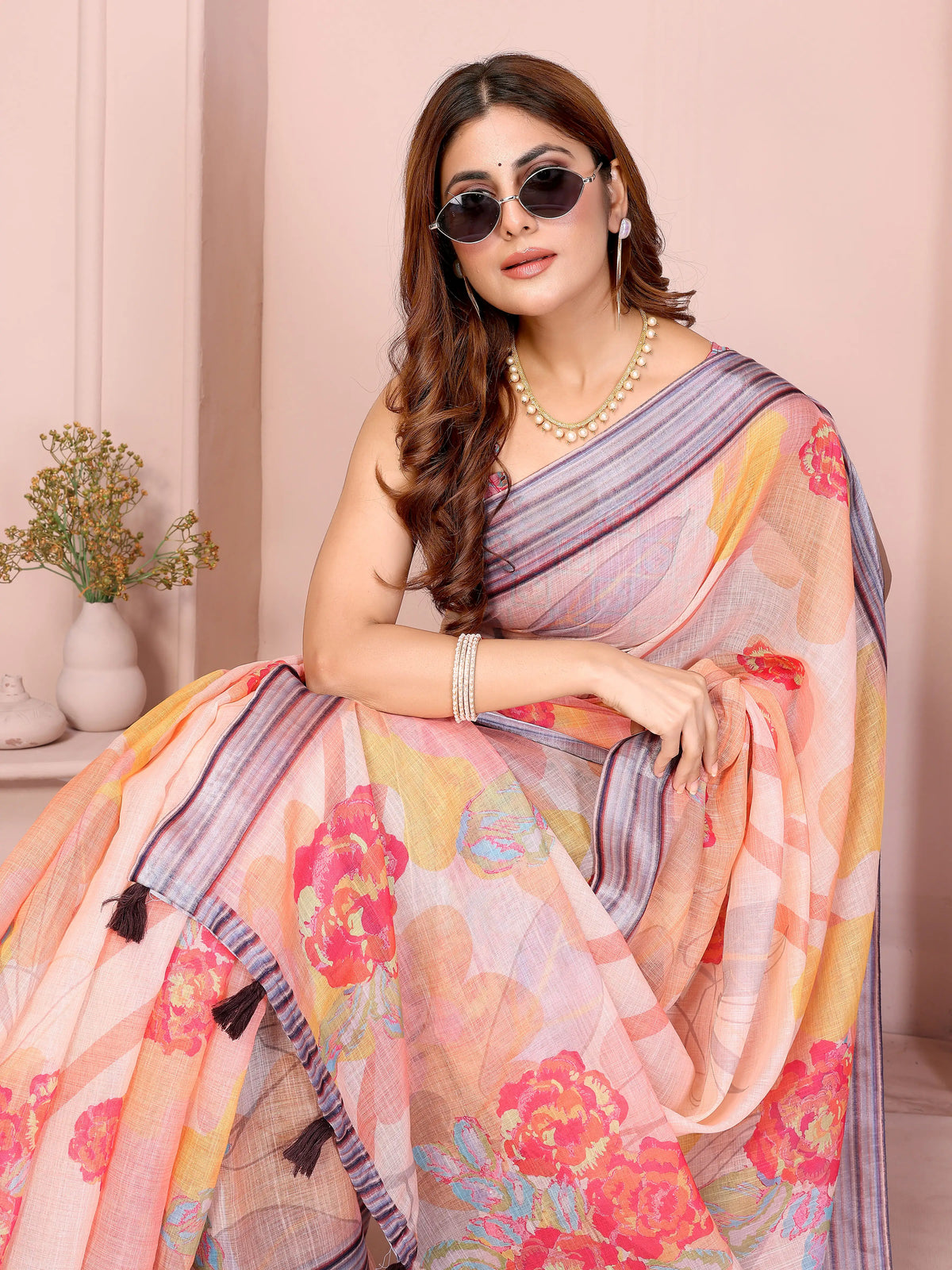 Close-up portrait of Soft Peach Digital Floral Print Saree showing contrast striped border and floral print detail
