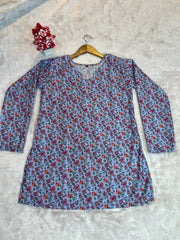Floral-patterned shirt on a hanger against a textured surface