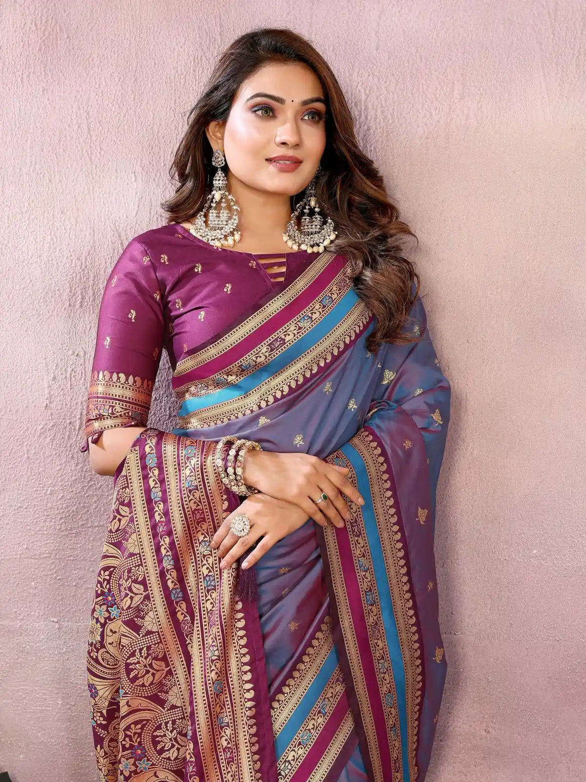 Woman wearing a traditional saree with a pink background