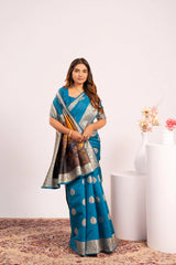 Woman wearing a blue saree with a white background