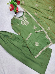 Green traditional outfit with embroidery on a white background
