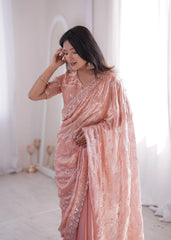 Woman wearing a pink saree with a white background