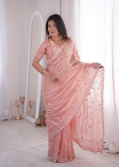Woman wearing a pink saree with a white background