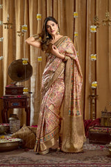 Woman in a floral saree standing in a decorated room with vintage decor.