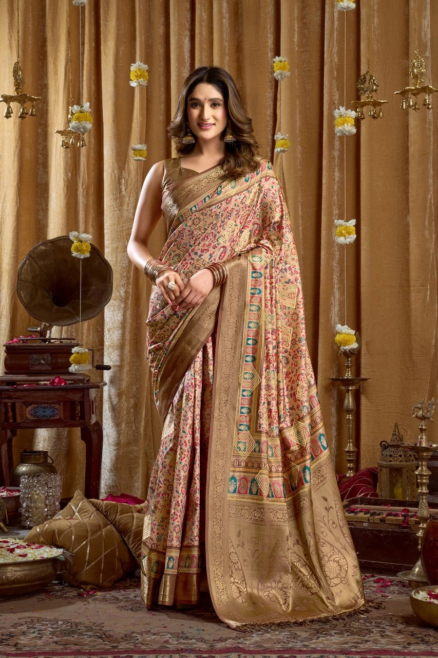 Woman in a traditional saree standing in a decorated room with ornate decor.