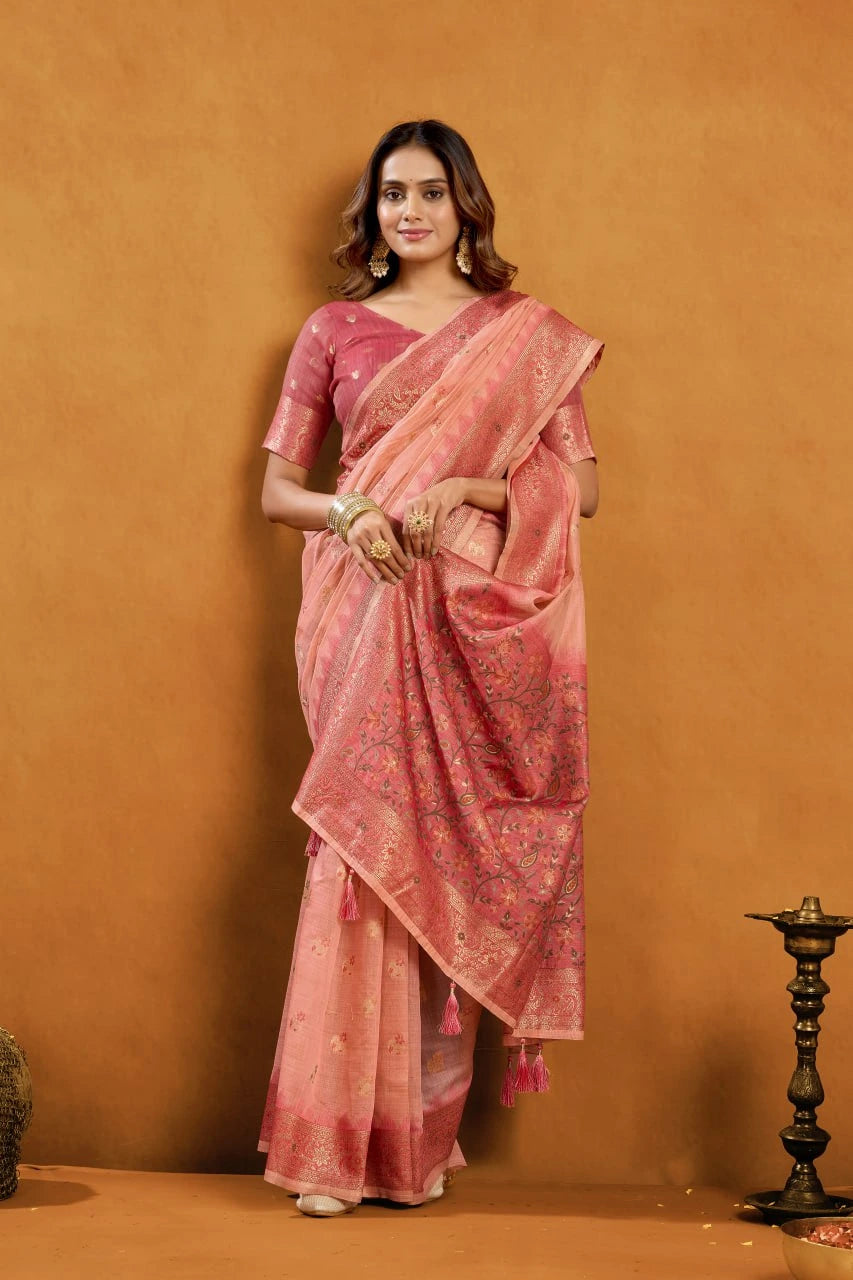 Woman wearing a pink saree with a subtle pattern against an orange background