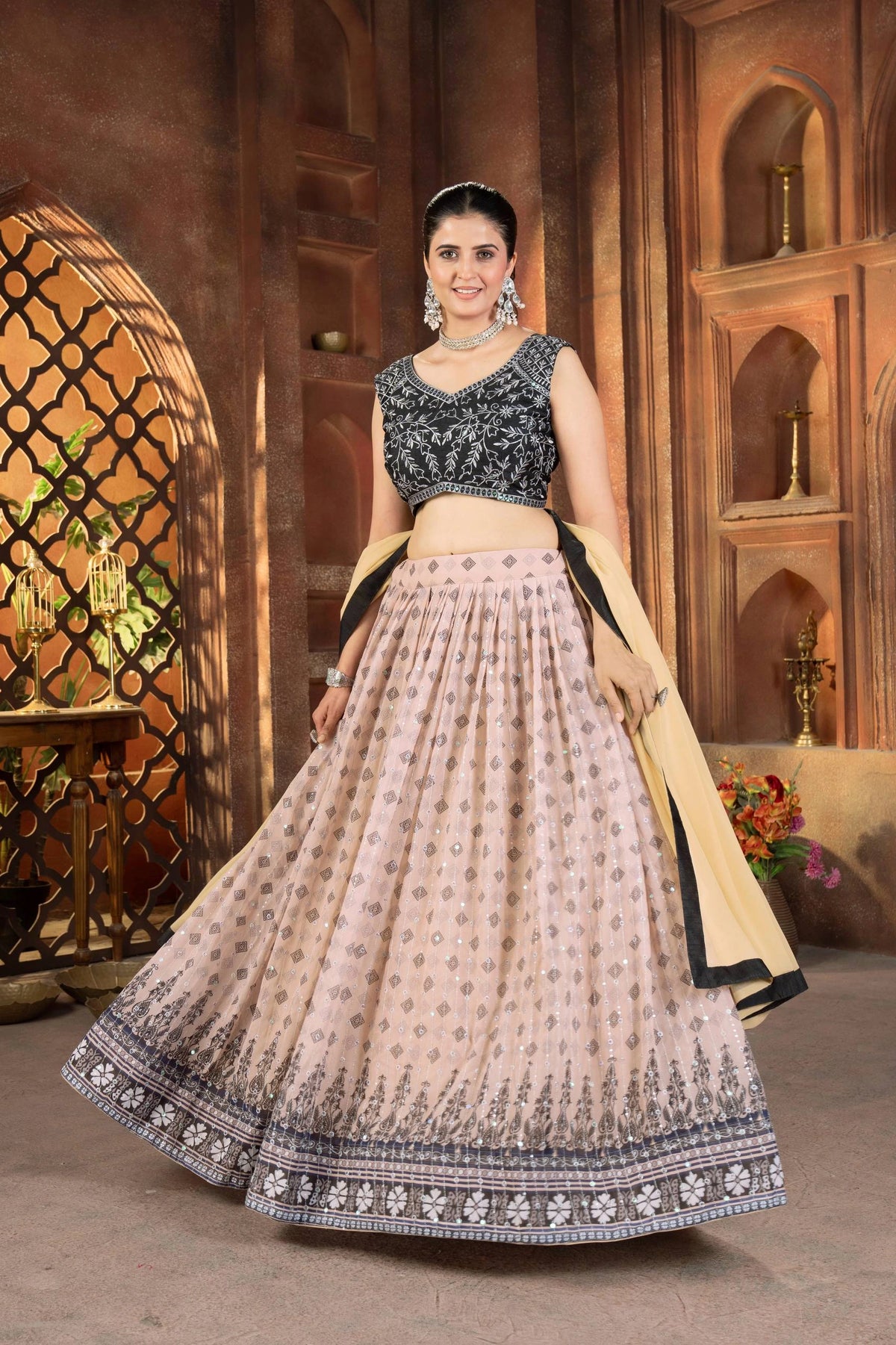 Woman in traditional outfit standing in a decorative indoor setting