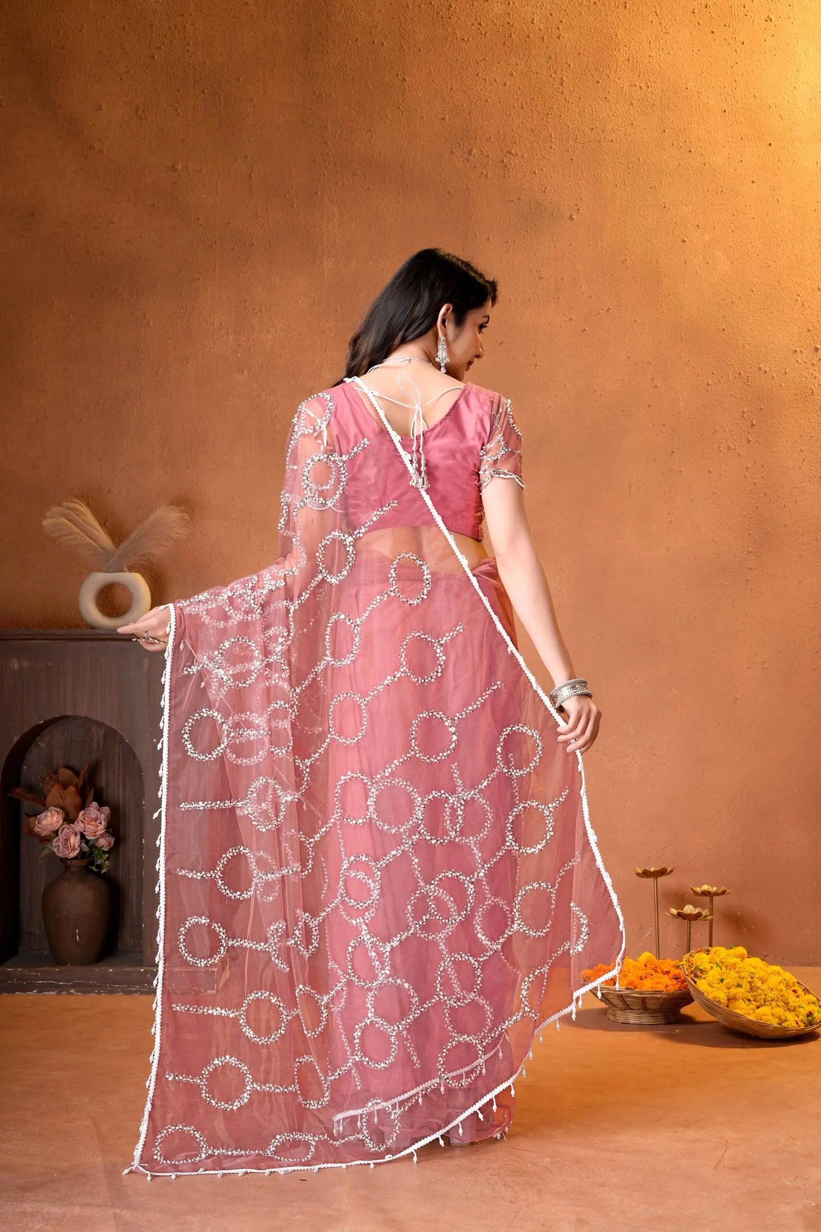 Premium ethnic saree crafted with sparkling embellishments, elegant patterns, and contemporary traditional styling.