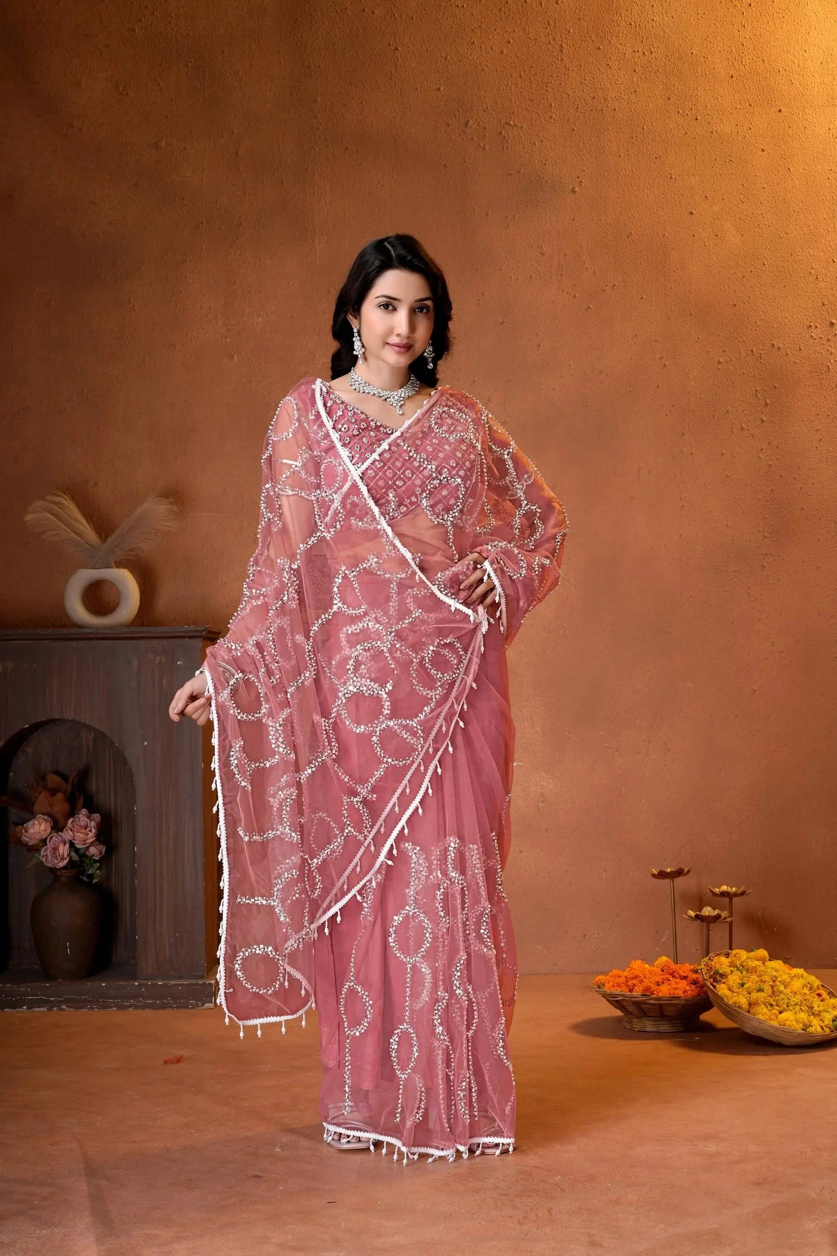 Designer party wear saree featuring a matching embroidered blouse, delicate beadwork, and graceful drape for weddings and celebrations.