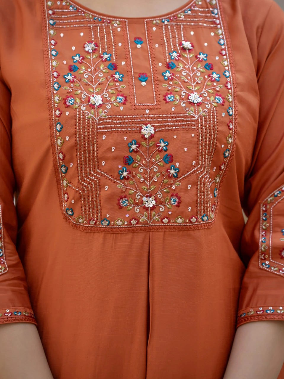Orange traditional outfit with intricate beadwork and embroidery
