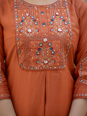 Orange traditional outfit with intricate beadwork and embroidery