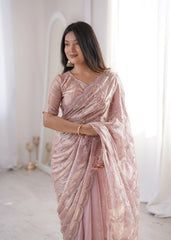 Woman wearing a pink saree with a white background