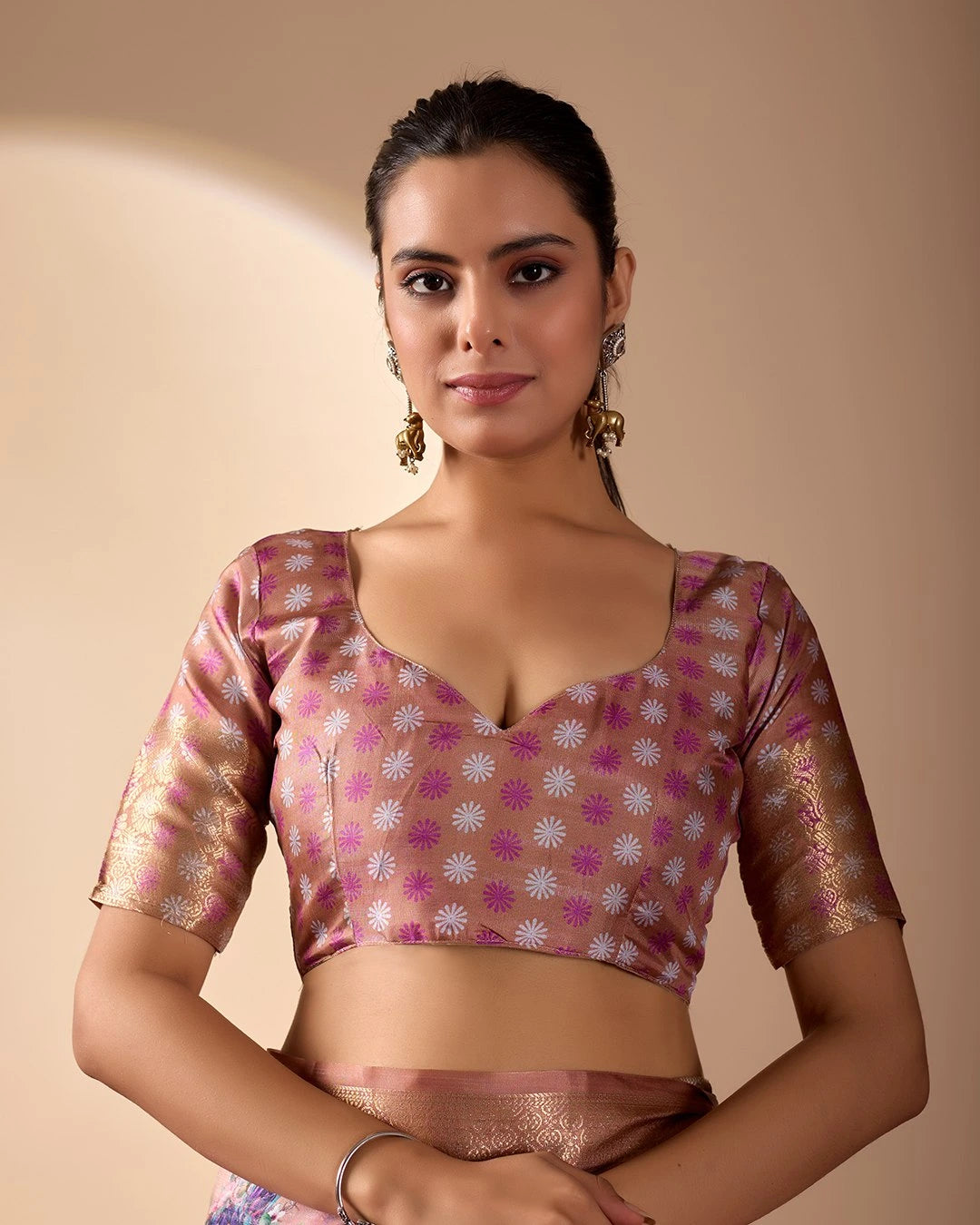Soft pink lichi silk saree featuring a vibrant floral digital print, an elegant gold zari woven border, and tassel details by Kalyanja.