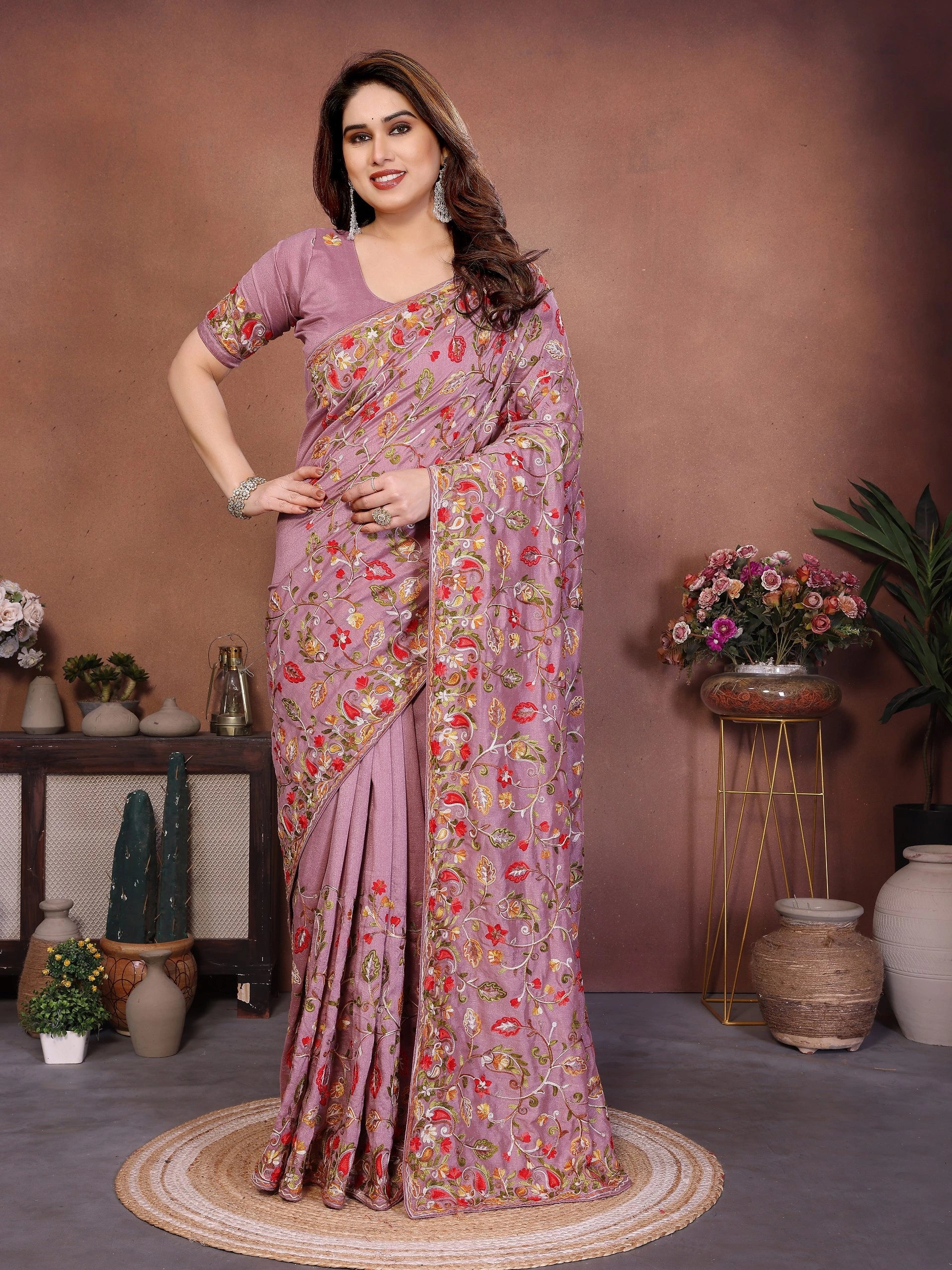Woman wearing a floral saree in a decorated indoor setting